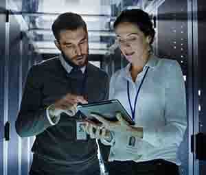 Data center engineers reviewing a report